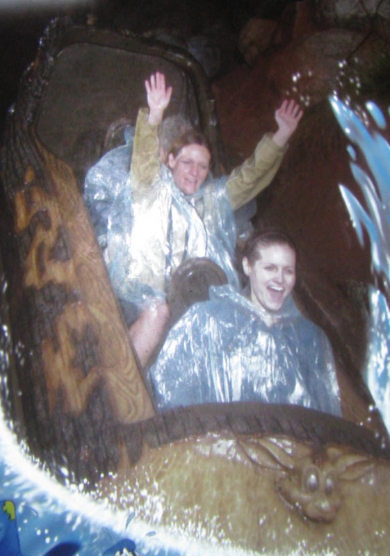 Two women screaming as they go down the last hill on Splash Mountain