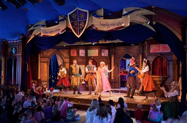 Image of the stage and actors from the Tangled show that plays at Disneyland Park at the Royal Theatre