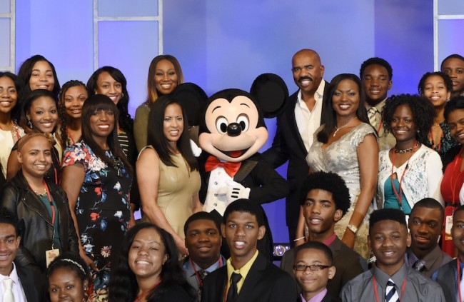 Disney Dreamers join singer Yolanda Adams (back row left of center), entertainer Steve Harvey (back row right of center), Mikki Taylor, editor-at-large for Essence Magazine (second to the left of Mickey Mouse), Michelle Ebanks, president of Essence Communications, Inc. (left of Mickey Mouse), Mickey Mouse, and Tracey D. Powell, executive champion of Disney Dreamers Academy (to the right of Mickey Mouse), March 8, 2015 to celebrate the commencement of Disney Dreamers Academy with Steve Harvey and Essence Magazine at Walt Disney World Resort. (Todd Anderson, Photographer)