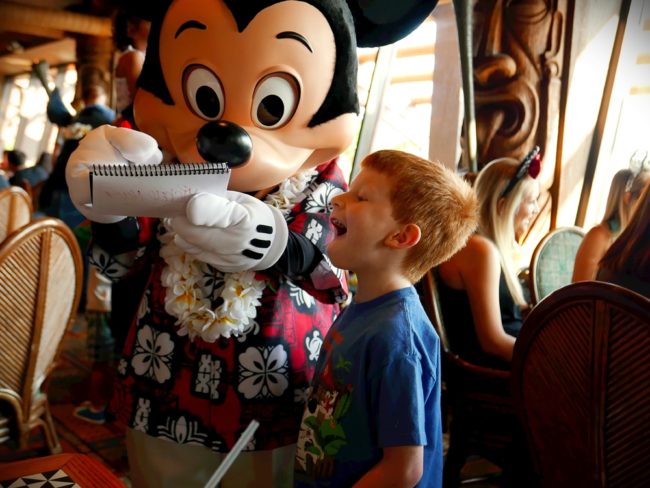 Boy getting Mickey's Autograph at 'Ohana